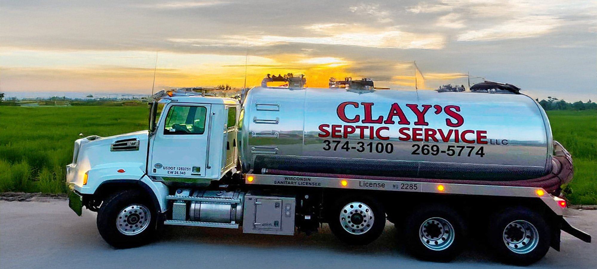 A Clay's Septic Service LLC tanker truck. On the side are phone numbers 347-3100 and 269-5774